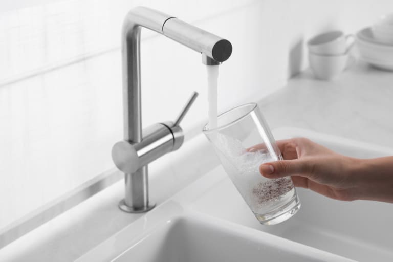 getting glass of water from kitchen sink tap
