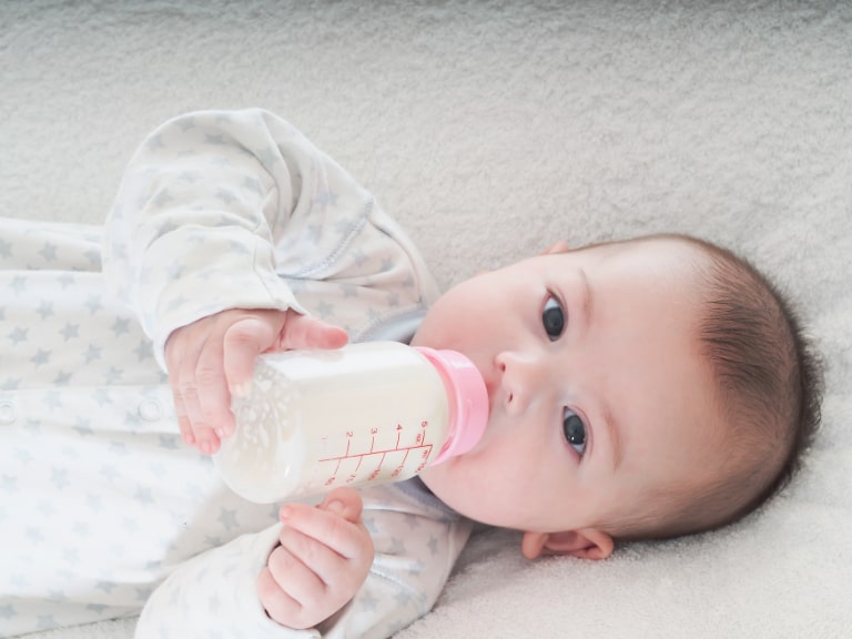 baby drinking formula from bottle